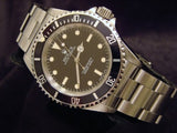 PRE OWNED MENS ROLEX STAINLESS STEEL SUBMARINER WITH A BLACK DIAL 14060