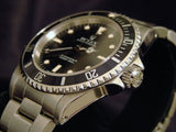 PRE OWNED MENS ROLEX STAINLESS STEEL SUBMARINER WITH A BLACK DIAL 14060