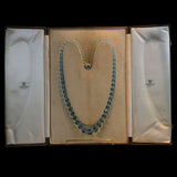 A BEAUTIFUL LONG NECKLACE OF FACETED AQUAMARINE BEADS RETAILED BY THE GOLDSMITHS AND SILVERSMITHS Co., c.1930