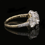 AN OLD EUROPEAN CUT DIAMOND THREE STONE RING IN PLATINUM AND 18CT GOLD BY HANCOCKS