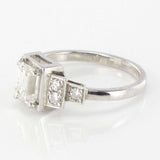 Emerald cut diamond ring with brilliant diamonds