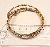 Lot of 3 semi-rigid bracelets in rose, white and yellow gold, with faceted beads, diameter 6 cm, weight 22.40 g