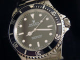 PRE OWNED MENS ROLEX STAINLESS STEEL SUBMARINER WITH A BLACK DIAL 14060