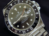PRE OWNED MENS ROLEX STAINLESS STEEL GMT-MASTER WITH A BLACK DIAL 16700